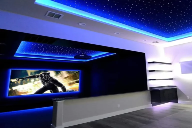 blue home theater led lighting with movie showing on the wall with a guy in a black suit also showing star ceilings