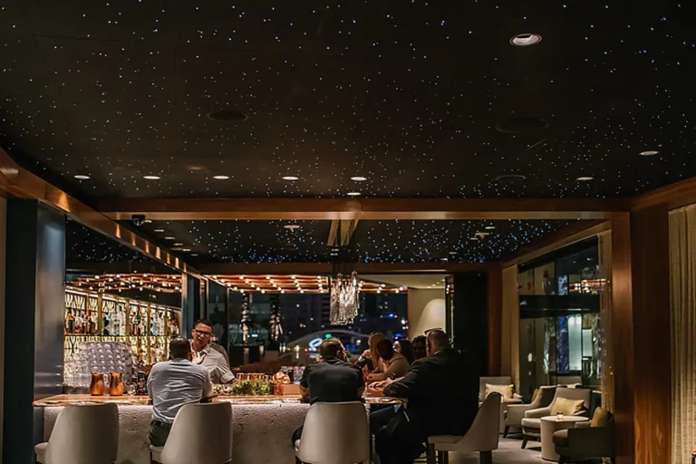 hotel scene with people at a bar with an epixsky star ceiling at statler hotel.